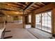 Unfinished basement with framed walls, exposed ceiling, and a sliding glass door at 7100 Hasentree Club Dr, Wake Forest, NC 27587