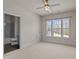 Bright bedroom features three large windows, neutral carpet, and an ensuite bathroom at 7100 Hasentree Club Dr, Wake Forest, NC 27587