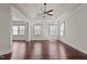 Spacious bedroom with tray ceiling, hardwood floors, and multiple windows providing ample natural light at 7100 Hasentree Club Dr, Wake Forest, NC 27587