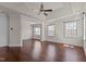 Spacious bedroom with tray ceiling, hardwood floors, and multiple windows providing ample natural light at 7100 Hasentree Club Dr, Wake Forest, NC 27587