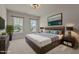 Comfortable bedroom featuring a queen bed, stylish lighting, and natural light from two windows at 7100 Hasentree Club Dr, Wake Forest, NC 27587