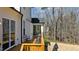 Side view of a spacious wooden deck with outdoor seating and views of the surrounding trees at 7100 Hasentree Club Dr, Wake Forest, NC 27587