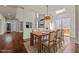 Elegant dining room features hardwood floors, skylight, and modern chandelier at 7100 Hasentree Club Dr, Wake Forest, NC 27587