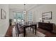 Staged dining room with hardwood floors, modern light fixture, and a sideboard at 7100 Hasentree Club Dr, Wake Forest, NC 27587