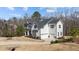 Side view of a beautiful two-story home with a three-car garage and a well-manicured lawn at 7100 Hasentree Club Dr, Wake Forest, NC 27587