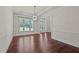 Bright foyer featuring large window, hardwood floors, and views to the front entrance at 7100 Hasentree Club Dr, Wake Forest, NC 27587