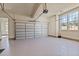 Spacious garage with epoxy floors, a window, and an automatic garage door opener at 7100 Hasentree Club Dr, Wake Forest, NC 27587