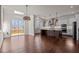 Open-concept kitchen boasts stainless steel appliances, dark island and hardwood flooring at 7100 Hasentree Club Dr, Wake Forest, NC 27587