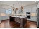 Spacious kitchen with a large center island, pendant lighting, and stainless steel appliances at 7100 Hasentree Club Dr, Wake Forest, NC 27587