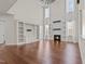 Open living area with built-in bookshelves, a fireplace, and abundant natural light from the tall windows at 7100 Hasentree Club Dr, Wake Forest, NC 27587