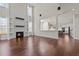 Living room featuring a fireplace, tall windows, and a view into the adjacent kitchen at 7100 Hasentree Club Dr, Wake Forest, NC 27587
