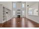 Bright living room with built-in shelving, a fireplace, and tall windows with natural light at 7100 Hasentree Club Dr, Wake Forest, NC 27587