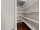 A spacious walk-in pantry offers ample storage with multiple shelves and hardwood floors at 7100 Hasentree Club Dr, Wake Forest, NC 27587