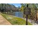 A pond for resident fishing with a fishing dock and posted rules at 7100 Hasentree Club Dr, Wake Forest, NC 27587