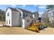 Rear exterior view of a two-story home with a wooden deck and a spacious backyard at 7100 Hasentree Club Dr, Wake Forest, NC 27587
