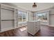Bright walk-in closet featuring custom shelving, hanging rods, a center island, and a large window for ample light at 7100 Hasentree Club Dr, Wake Forest, NC 27587
