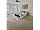 Spacious bedroom with carpeted floors, two bright windows, and a comfortable king-sized bed at 723 Whitt Town Rd Rd, Roxboro, NC 27574