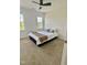 Bedroom featuring two windows, a ceiling fan and a bed with a brown throw blanket at 723 Whitt Town Rd Rd, Roxboro, NC 27574