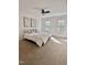 Bright bedroom with neutral decor, plush bedding, and natural light streaming through the windows at 723 Whitt Town Rd Rd, Roxboro, NC 27574