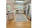 Bright kitchen featuring white cabinets, stainless steel appliances, breakfast bar and hardwood flooring at 723 Whitt Town Rd Rd, Roxboro, NC 27574