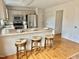 Bright kitchen featuring white cabinets, stainless steel appliances, breakfast bar and hardwood flooring at 723 Whitt Town Rd Rd, Roxboro, NC 27574