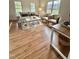 Bright living room with wood floors, neutral decor, and plenty of natural light from large windows at 723 Whitt Town Rd Rd, Roxboro, NC 27574
