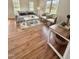 Bright living room with wood floors, neutral decor, and plenty of natural light from large windows at 723 Whitt Town Rd Rd, Roxboro, NC 27574
