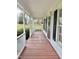 Charming front porch with wood flooring and white columns at 723 Whitt Town Rd Rd, Roxboro, NC 27574
