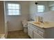 Bathroom with window, marbled countertop sink, toilet, and neutral-toned walls at 736 Core Rd Rd, Dunn, NC 28334