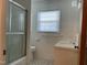 Bright bathroom with white tile, shower, window, and modern fixtures at 736 Core Rd Rd, Dunn, NC 28334