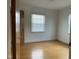 Well-lit bedroom featuring hardwood floors, two windows, and view of other rooms; move-in ready at 736 Core Rd Rd, Dunn, NC 28334