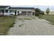 Gravel driveway leading to a white house with a carport and gazebo at 736 Core Rd Rd, Dunn, NC 28334