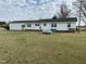 Rear view of the ranch-style home on a large grassy lot at 736 Core Rd Rd, Dunn, NC 28334