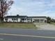 Charming single story home featuring a carport, green lawn, mature landscaping, and classic curb appeal at 736 Core Rd Rd, Dunn, NC 28334