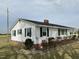 Charming ranch-style home with black shutters, brick foundation, and green shrubbery at 736 Core Rd Rd, Dunn, NC 28334