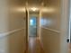 Well-lit hallway features hardwood floors, wainscoting and leads to a bathroom at 736 Core Rd Rd, Dunn, NC 28334