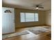 Bright living room with hardwood floors, ceiling fan, and large window offering natural light at 736 Core Rd Rd, Dunn, NC 28334