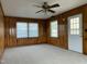 Cozy room features wood paneling, new carpet, a ceiling fan with lights, and lots of sunlight at 736 Core Rd Rd, Dunn, NC 28334