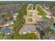 An aerial view of a charming home adjacent to a lush green golf course with mature trees at 7516 Mourning Dove Dr, Sanford, NC 27332