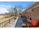 Back deck with outdoor seating, grill, string lights, and a view of the landscaped backyard and golf course at 7516 Mourning Dove Dr, Sanford, NC 27332