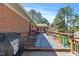 Spacious back deck with ample seating, colorful accents, and a grill for outdoor entertaining at 7516 Mourning Dove Dr, Sanford, NC 27332