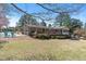 Expansive backyard featuring a large deck, lush lawn, and mature trees for outdoor enjoyment at 7516 Mourning Dove Dr, Sanford, NC 27332