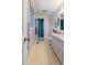 Hall bathroom featuring a walk-in shower, pastel pink vanity, and neutral tile flooring at 7516 Mourning Dove Dr, Sanford, NC 27332