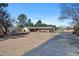 Well-maintained single-story home with a large yard and mature trees in a tranquil setting at 7516 Mourning Dove Dr, Sanford, NC 27332