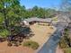 Landscaped front yard featuring a well-maintained lawn, flowering bushes, and mature trees at 7516 Mourning Dove Dr, Sanford, NC 27332