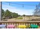 Golf course view from deck featuring stools, string lights, and the beautiful greenery of the course at 7516 Mourning Dove Dr, Sanford, NC 27332