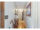 Charming hallway featuring hardwood floors and decorative wallpaper, leading to other areas of the home at 7516 Mourning Dove Dr, Sanford, NC 27332