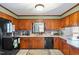 Traditional kitchen features wood cabinetry and white countertops at 7516 Mourning Dove Dr, Sanford, NC 27332