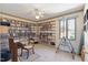 Dedicated office space with built-in shelving and a cozy corner for work or hobbies, bathed in sunlight at 7516 Mourning Dove Dr, Sanford, NC 27332