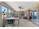 Bright sunroom with neutral carpet, brick accent wall, and large windows offering outdoor views and natural light at 7516 Mourning Dove Dr, Sanford, NC 27332